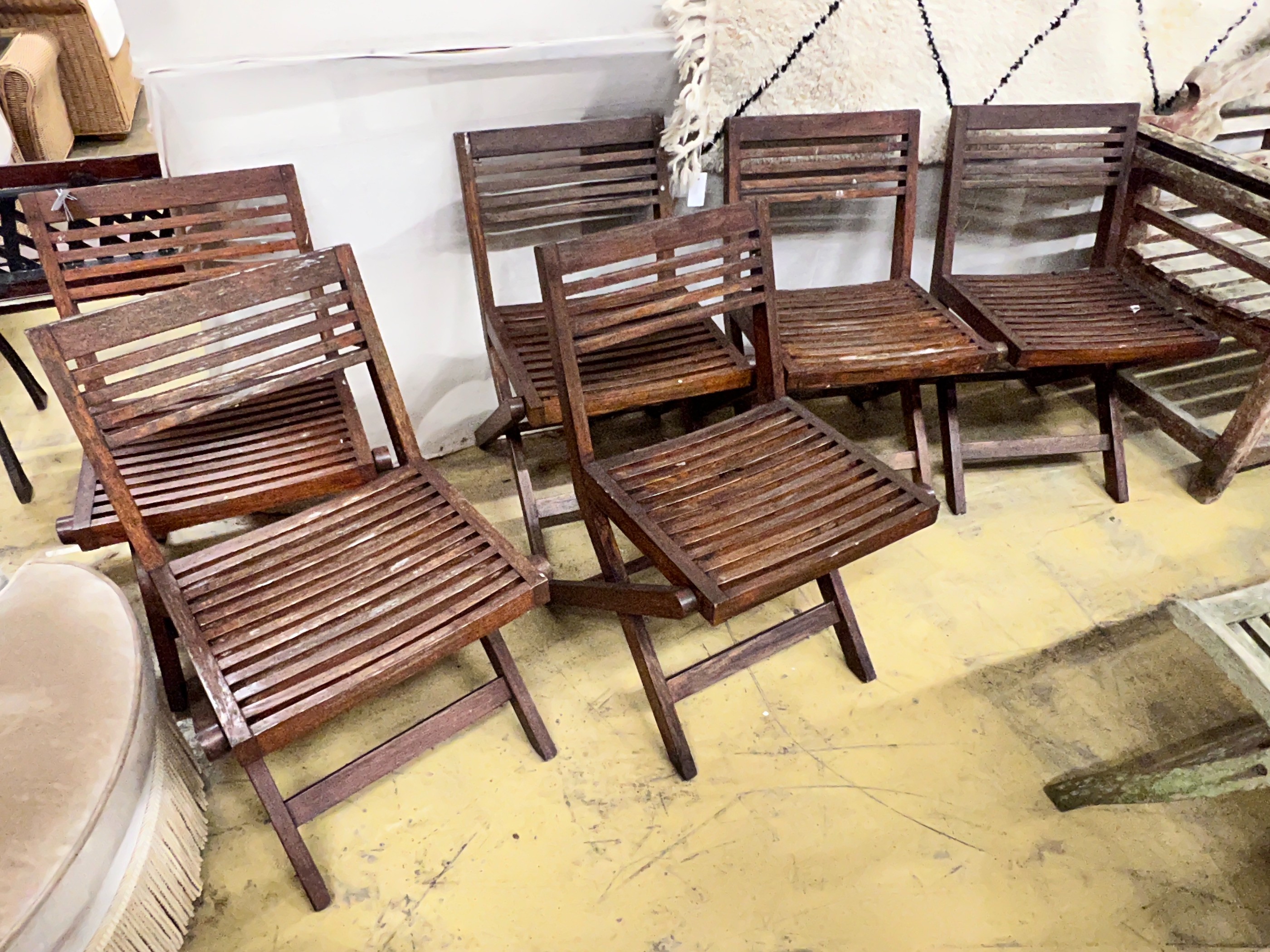 A set of six slatted teak garden chairs